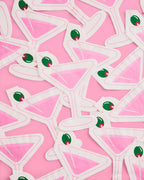 White geometric shapes with green and red accents on a pink background