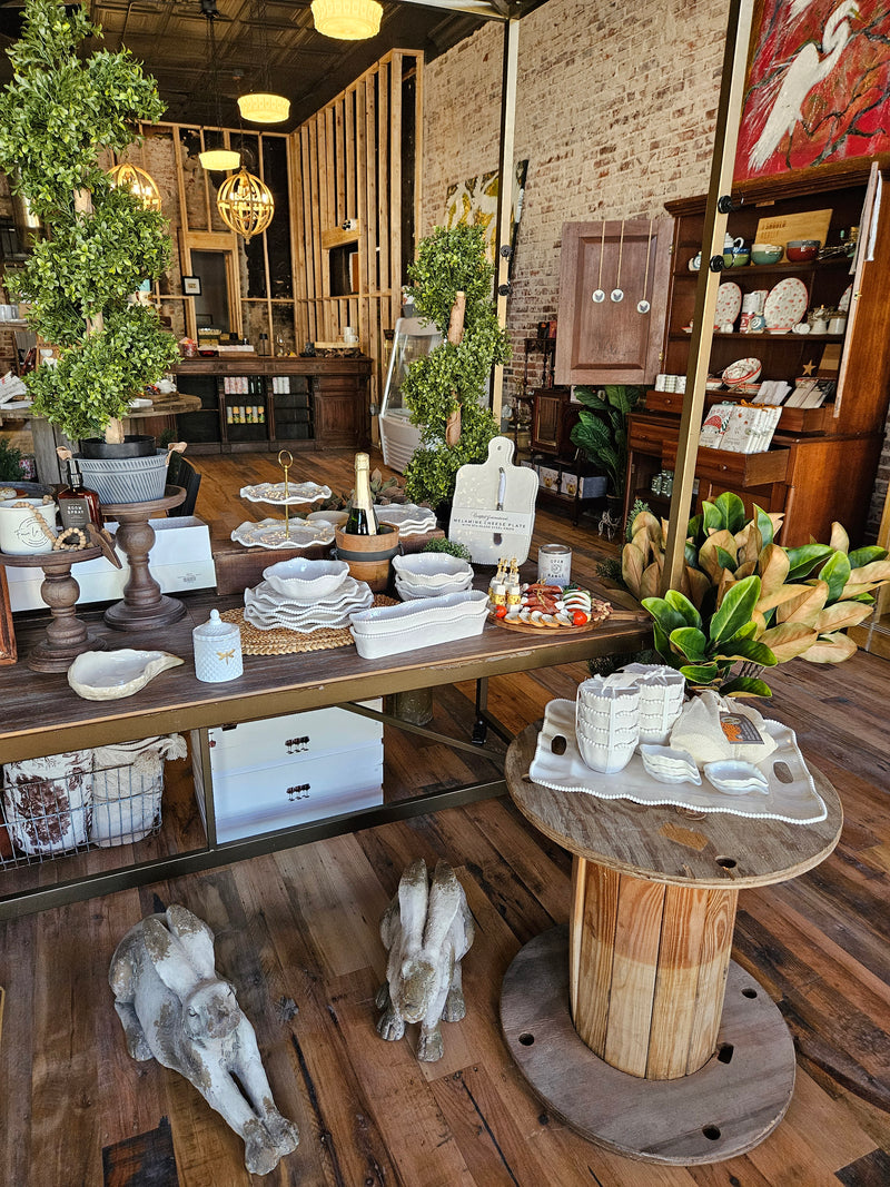 Store interior with decorative items on tables and shelves.