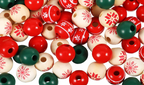 A pile of round wooden beads in red, dark green, and natural cream, decorated with red snowflake and geometric patterns, on a white background.